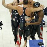 The whole U.S. men's 4x100 freestyle relay team celebrate--from left, Weber-Cole, Lezak (back turned to camera), Phelps and Cullen Jones.